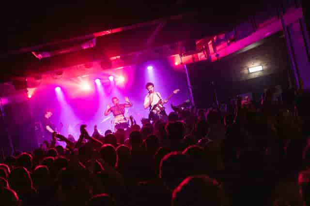 Vibrant live music event at Castle & Falcon with dynamic lighting and engaged audience.