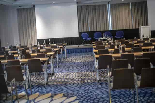 Brussels Ballroom 2 setup for a conference with tables, chairs, and soft lighting.
