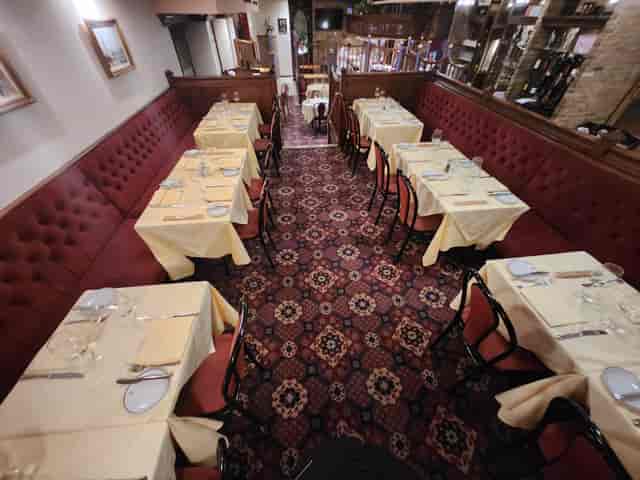 Semi-private dining space in Bolton's Restaurant with yellow tablecloths for intimate events.