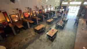 Spacious event venue with warm lighting, ideal for corporate meetings and social events.