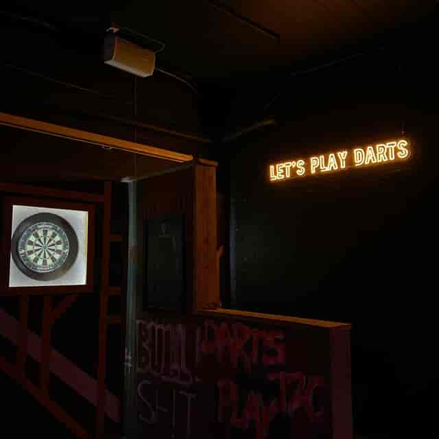 Vibrant event space with dartboard for team-building and social gatherings at The Lost Weekend.