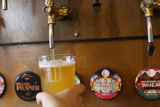Vibrant Mondo Brewing taproom with sleek beer taps, ideal for networking events.