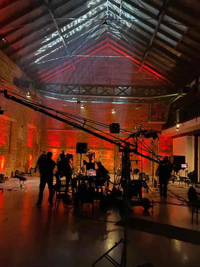 Dynamic event setup with strategic lighting in rustic venue for impactful meetings.