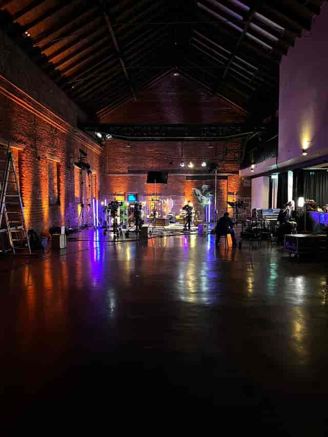Versatile event space with warm lighting, ideal for live productions and creative events.