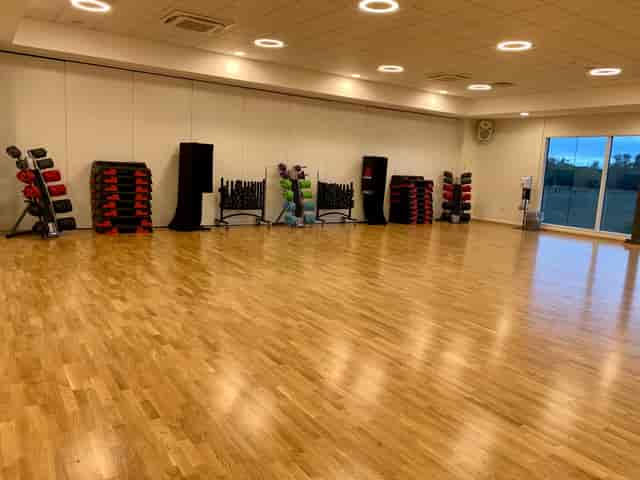 Spacious gym in Basildon with wooden floor for fitness classes and wellness events.