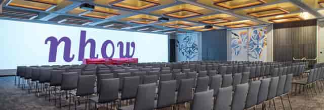 Conference room at Inspire, nhow Brussels, with vibrant chairs for events and presentations.