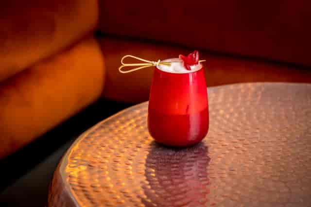 Vibrant cocktail on copper table at The Vault, perfect for networking events and celebrations.