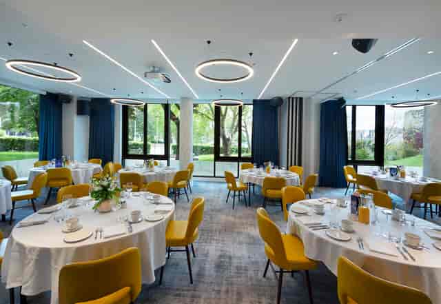 Thames Suite event space with elegant round tables and natural light for corporate gatherings.