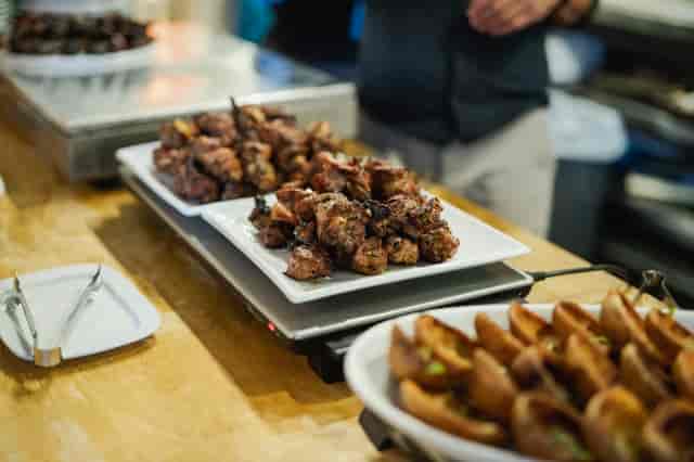 Buffet setup with grilled meats at Covent Garden Kitchen for events and gatherings.