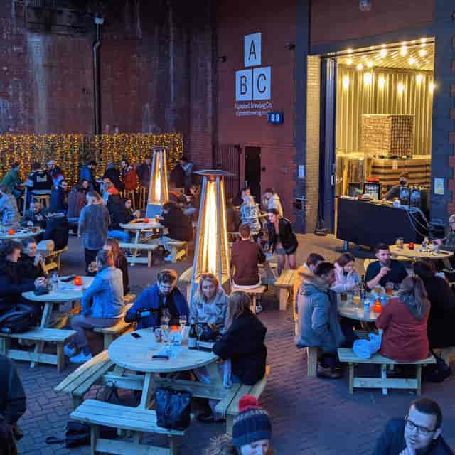 Outdoor event space at Alphabet Brewing Company with picnic tables for social gatherings.