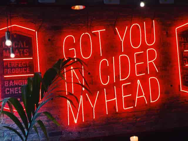 Vibrant neon sign at The Bath Stable for casual gatherings and themed events.