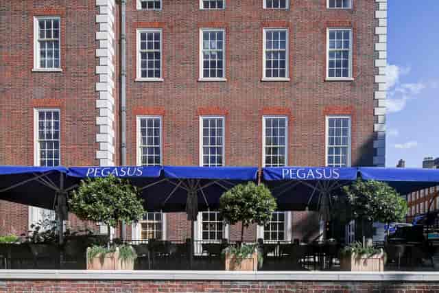 Outdoor venue at Pegasus Bar, blue awnings, ideal for summer social events and networking.