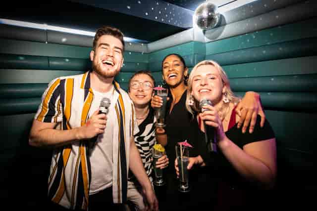 Lively karaoke night at Lucky Voice Soho with friends enjoying drinks and entertainment.