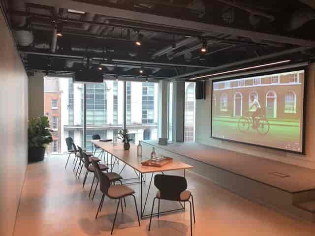 Modern Shirley Jackson Boardroom with large screen for versatile meetings and presentations.