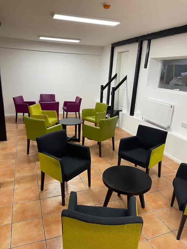 Modern Kingdom Hall with vibrant purple and green seating for casual gatherings.