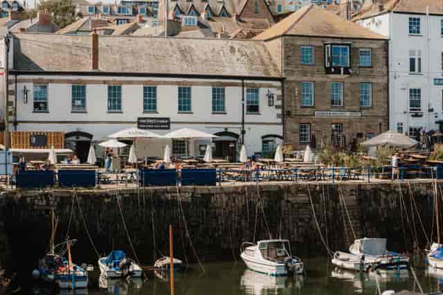 Charming waterfront venue for events with outdoor seating and scenic views.