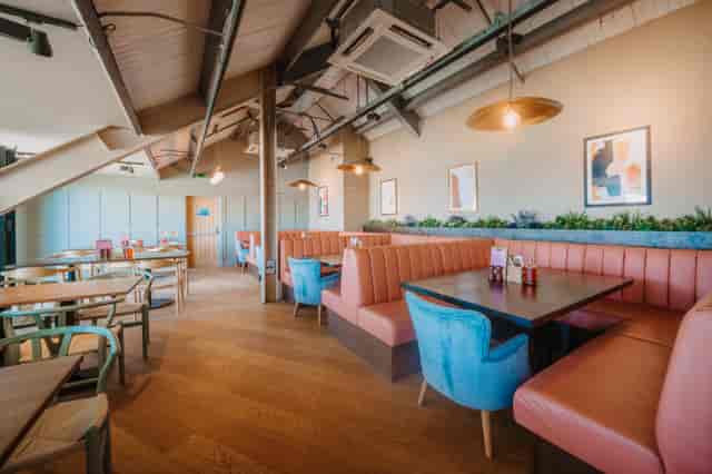 Modern dining space at Longboard Bar, ideal for casual meetings and events.
