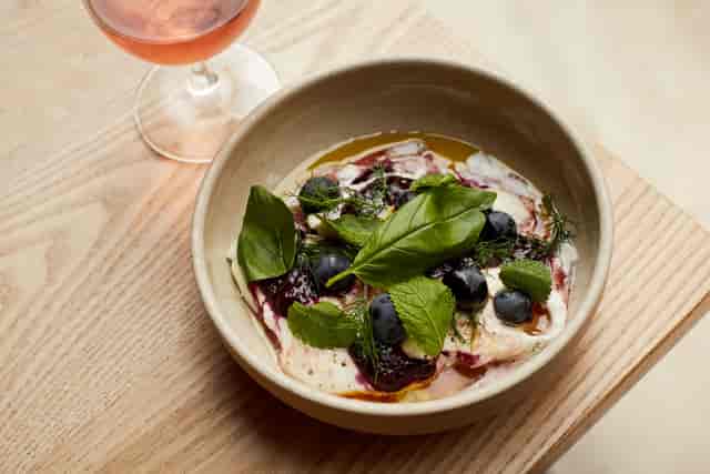 Elegant dish with blueberries and rosé at Crispin Pavilion for upscale events.