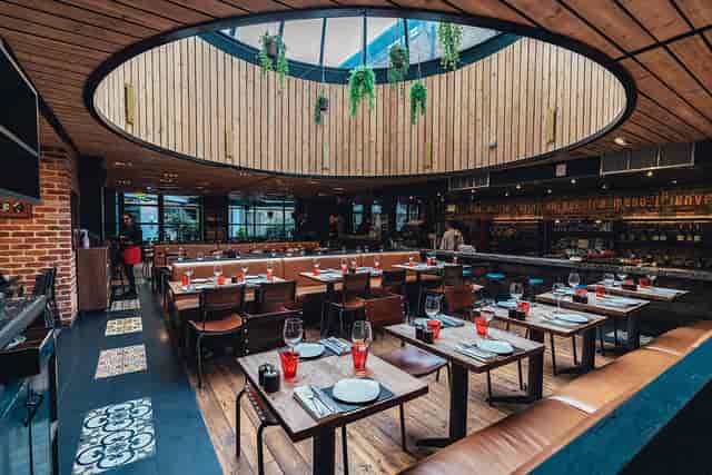 Modern restaurant interior with skylight, perfect for corporate events and gatherings.