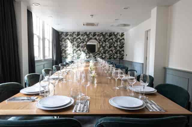 Elegant dining room with fine china, perfect for meetings and gatherings.