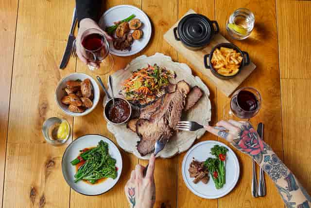 Dining table setup with brisket for corporate events and social gatherings.