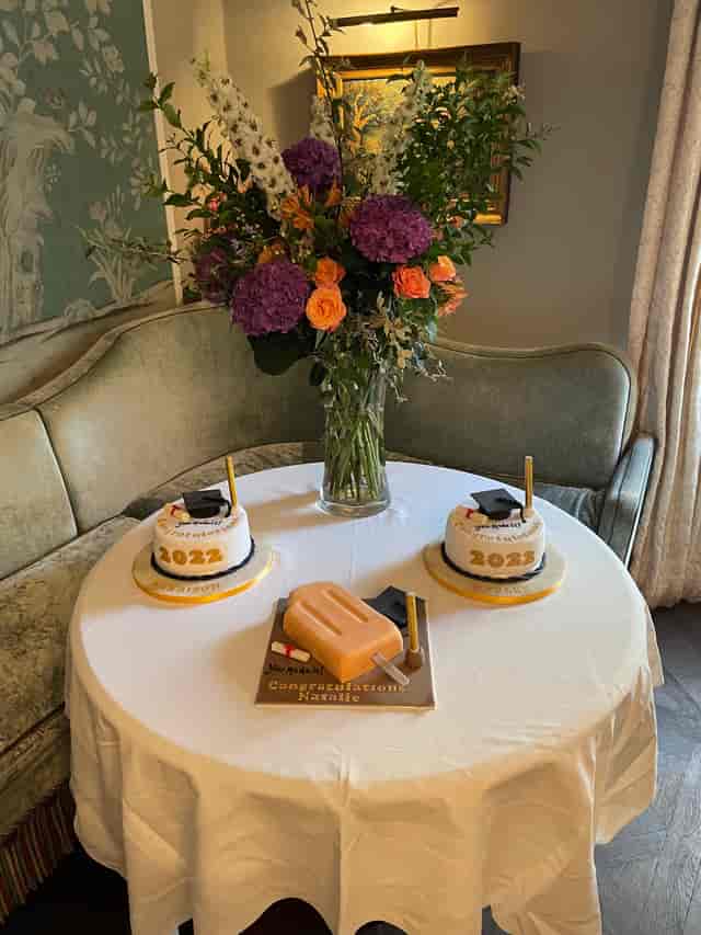 Elegant graduation cake display at No. Fifty Cheyne for a celebratory event.