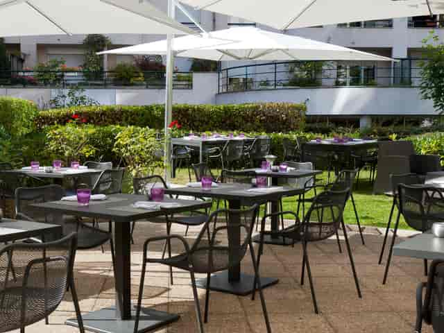 Outdoor event space at Novotel Paris with vibrant purple accents and greenery.
