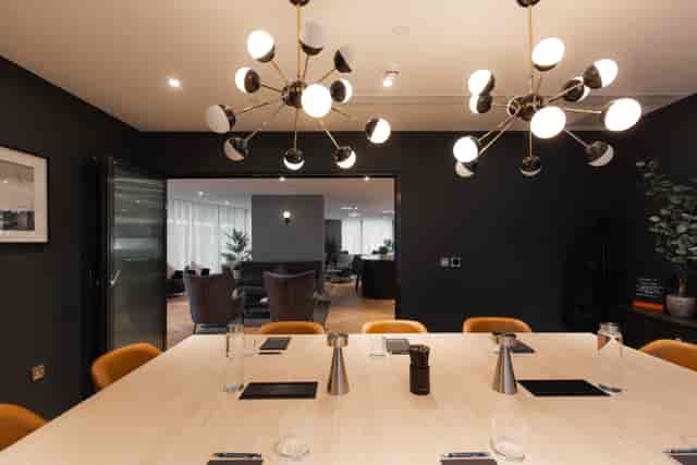 Modern meeting room with sleek table, ideal for corporate events and collaborations.