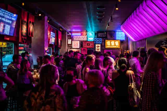 Vibrant networking event at Lucky Cat Bar with colorful decor and lively atmosphere.