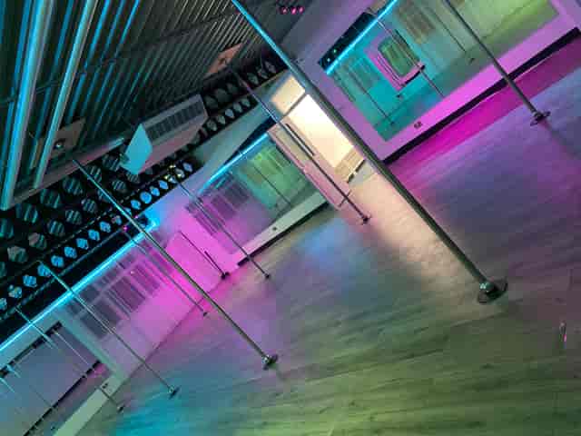 Versatile event space with wooden flooring, ideal for corporate meetings and social gatherings.