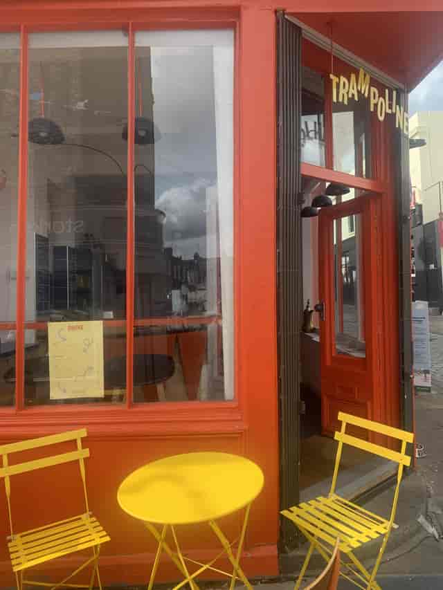 Vibrant trampoline venue entrance with bold orange doors for events and gatherings.