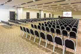 Spacious conference room with black chairs for corporate meetings at Crowne Plaza Rome.