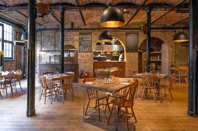 Stylish rustic dining room with warm wood tones, ideal for intimate gatherings and events.