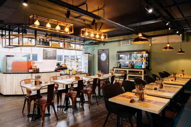 Modern Leslie Forster Suite restaurant with wooden tables, ideal for events and meetings.