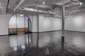 Spacious event space with polished floors, ideal for corporate meetings and social gatherings.