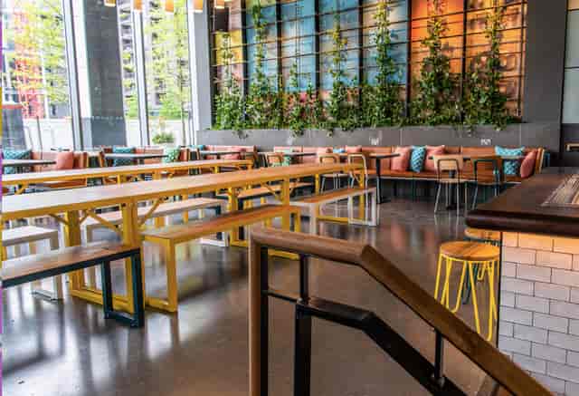 Vibrant Babel Beerhouse event space with communal seating for casual meetings and networking.
