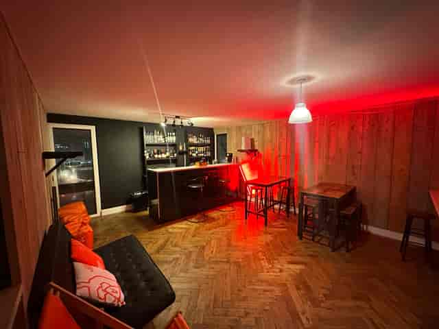 Stylish London Bridge Rooftop bar with warm wood accents, ideal for networking events.