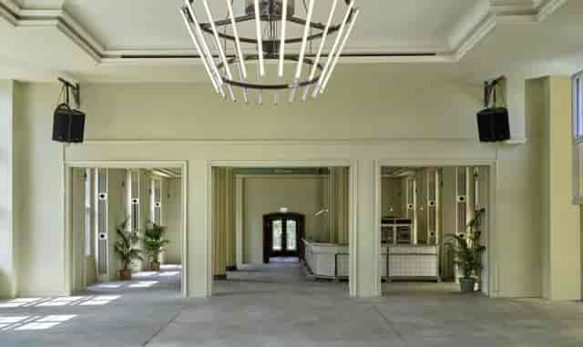 Spacious wedding venue with modern design, ideal for receptions and conferences.
