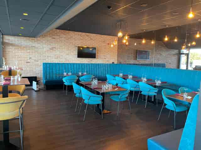 Modern dining space at The Clubhouse, Twickenham Stoop Stadium for events and gatherings.