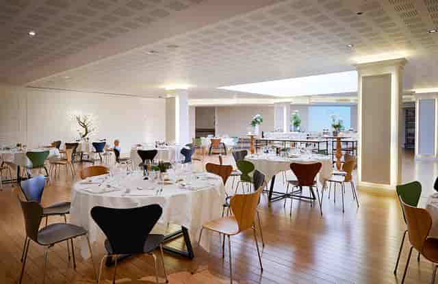 Elegant event space with round tables, ideal for corporate meetings and receptions.