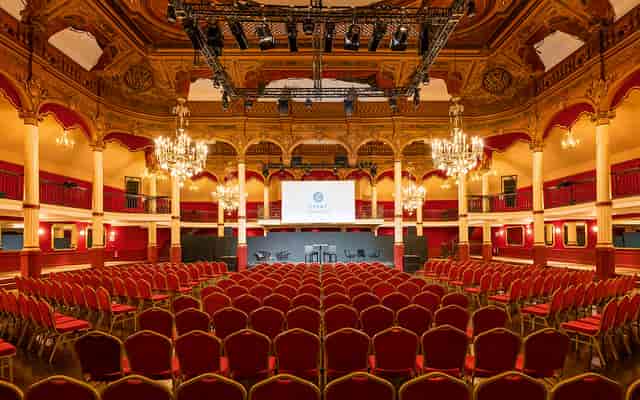 Elegant event space with chandeliers, ideal for conferences and gatherings.