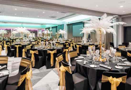 Elegant event space at The Rosewood - Woodlands with feather centerpieces for weddings.