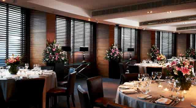 Elegant Sky Lounge dining space with floral centerpieces for upscale events and meetings.