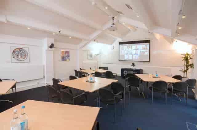 Hardy Room in De Morgan House, hybrid meeting space with large screen for events.