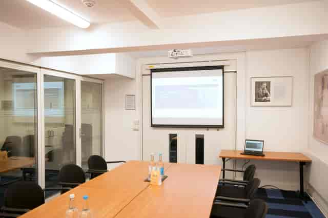 Burnside Room in De Morgan House: modern meeting space with large table, ideal for workshops.