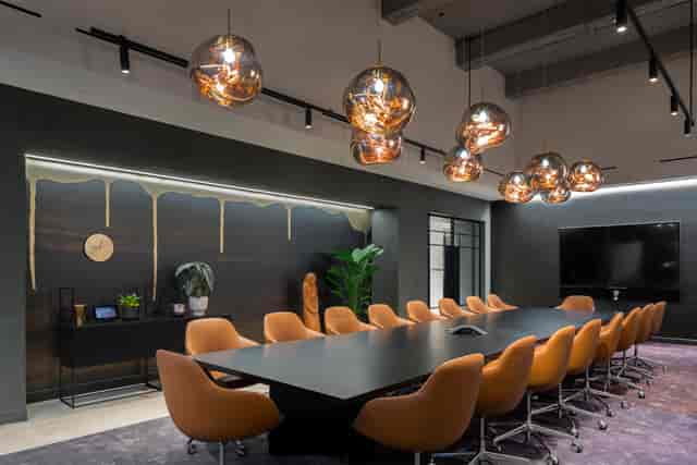 Modern conference room at Convene 75 Rockefeller Plaza with sleek table and warm chairs.