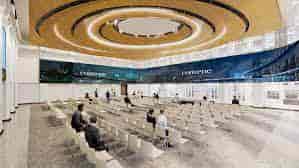 Modern event venue with circular ceiling, ideal for conferences and networking events.