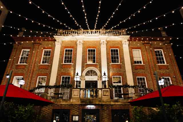 Elegant evening event venue with warm string lights and outdoor seating.