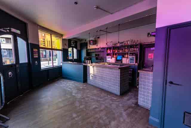 Modern event space with bar, ideal for casual gatherings and networking events.