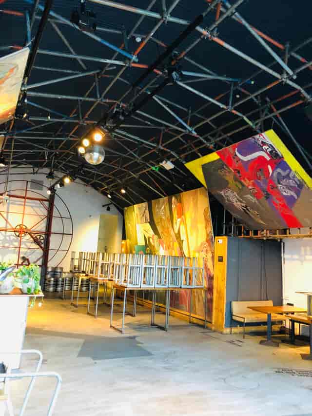 Industrial event space with exposed beams and disco ball for lively gatherings.